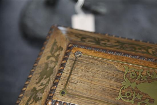 A Regency rosewood and brass inlaid sarcophagus shaped tea caddy, 13.75in.